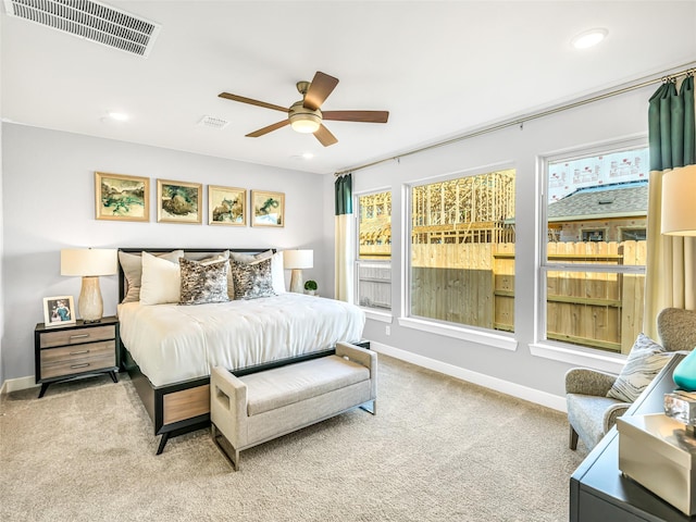 bedroom featuring light colored carpet and ceiling fan