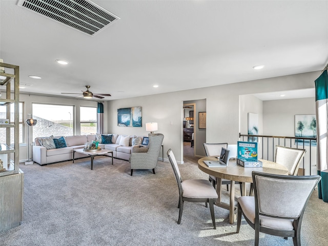 living room featuring carpet flooring and ceiling fan