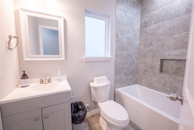 full bathroom with vanity, tiled shower / bath combo, and toilet