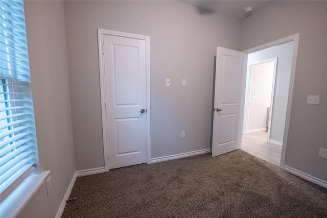 spare room featuring carpet flooring and a wealth of natural light