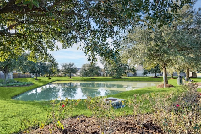 view of home's community featuring a water view and a lawn