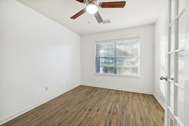 spare room with ceiling fan, hardwood / wood-style floors, and french doors