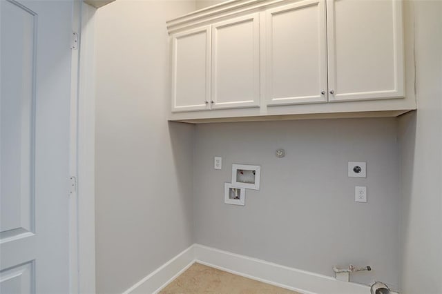 washroom featuring gas dryer hookup, hookup for a washing machine, cabinets, and hookup for an electric dryer