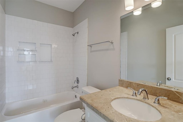 full bathroom featuring vanity, toilet, and tiled shower / bath combo