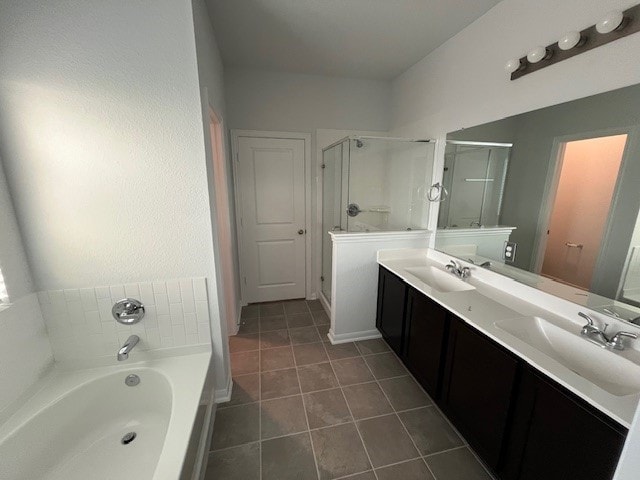 bathroom with tile patterned floors, vanity, and separate shower and tub