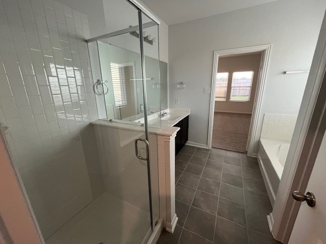 bathroom with tile patterned flooring, vanity, and independent shower and bath