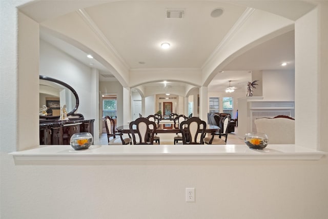 interior space featuring ceiling fan and ornamental molding