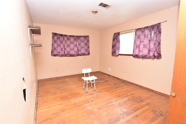 empty room with hardwood / wood-style floors