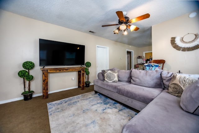 carpeted living room with ceiling fan and a textured ceiling