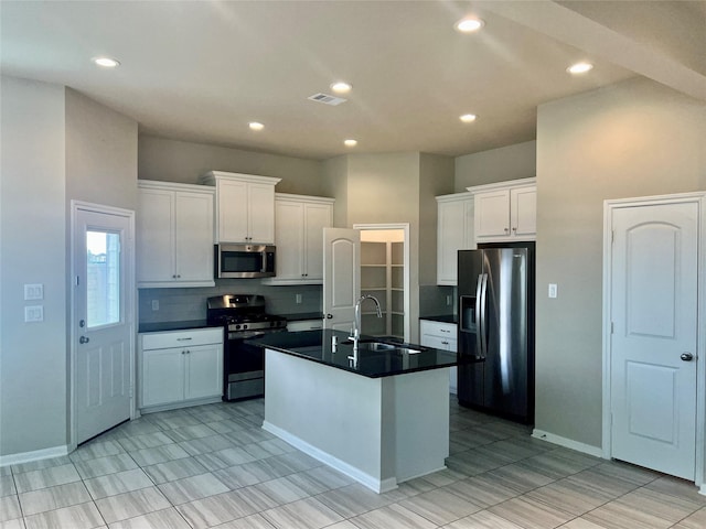 kitchen with white cabinetry, sink, decorative backsplash, a center island with sink, and appliances with stainless steel finishes