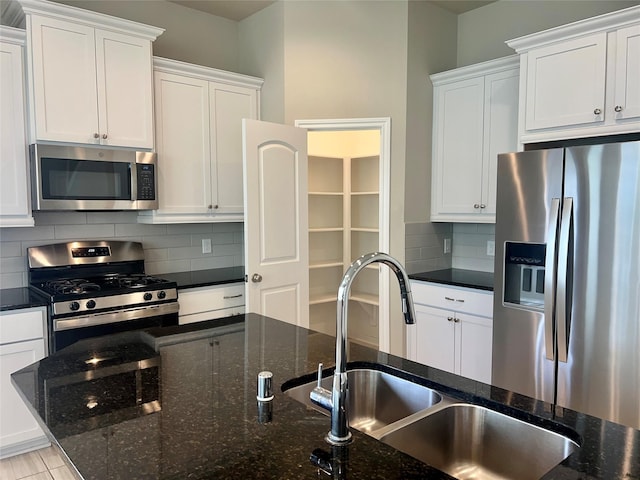 kitchen with appliances with stainless steel finishes and white cabinetry