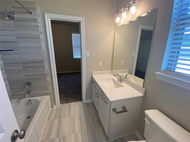 full bathroom featuring vanity, toilet, and tiled shower / bath