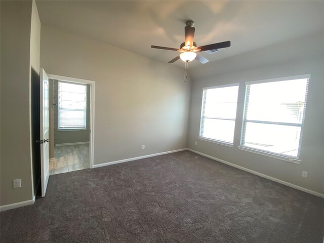 carpeted spare room featuring ceiling fan