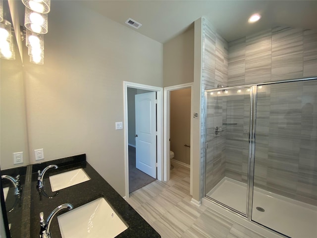 bathroom featuring hardwood / wood-style floors, vanity, toilet, and walk in shower