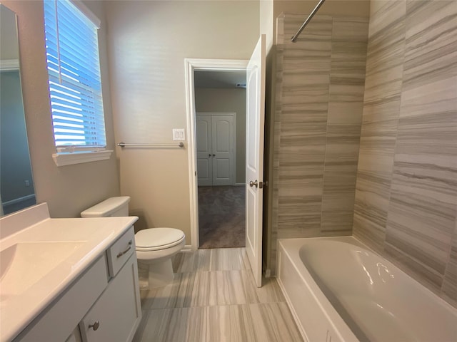 full bathroom with vanity, toilet, and tiled shower / bath