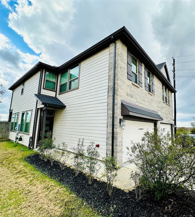 view of side of property featuring a yard and a garage