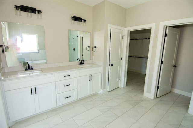 bathroom with tile patterned flooring, a bath, and vanity