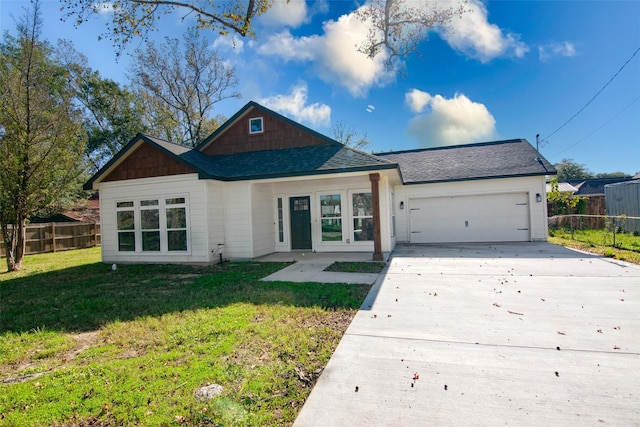 view of front of property featuring a garage and a front lawn