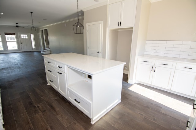 kitchen featuring dark hardwood / wood-style floors, ceiling fan, and white cabinetry