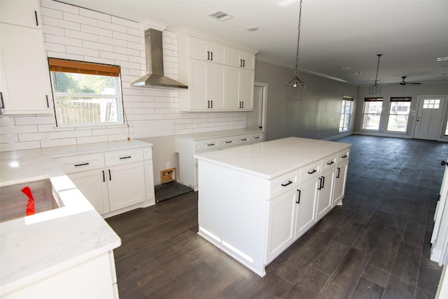 kitchen with white cabinets, wall chimney exhaust hood, and dark hardwood / wood-style flooring