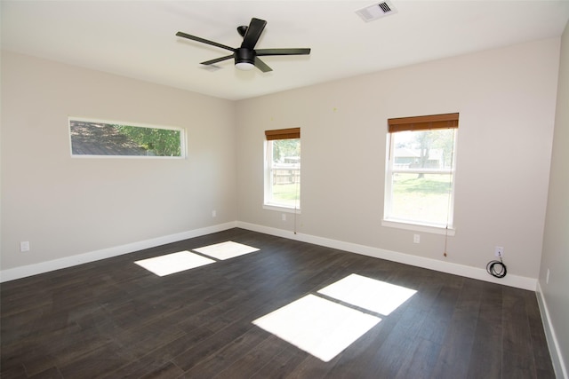 empty room featuring ceiling fan and dark hardwood / wood-style floors