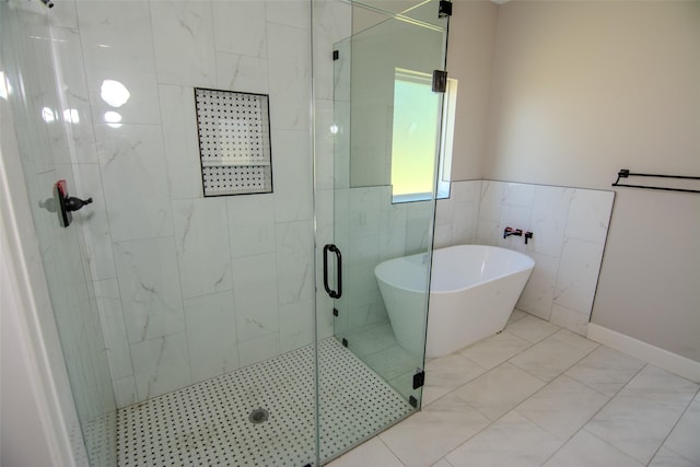 bathroom featuring independent shower and bath and tile walls