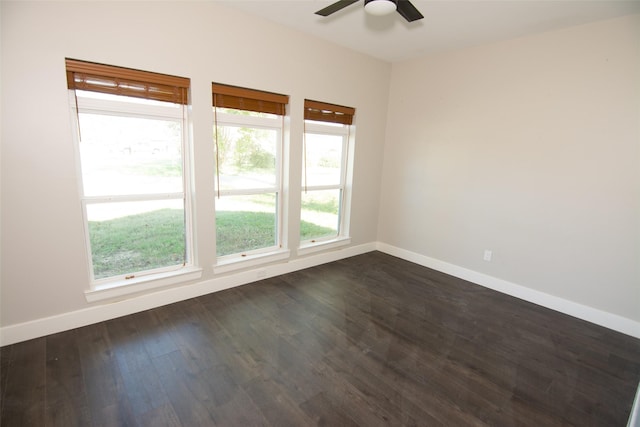 unfurnished room with dark hardwood / wood-style flooring and ceiling fan