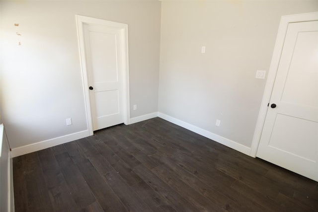 empty room featuring dark wood-type flooring