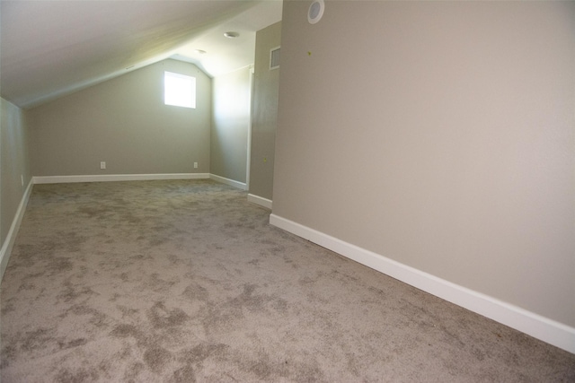 bonus room featuring carpet flooring and vaulted ceiling