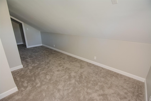 bonus room featuring light colored carpet and vaulted ceiling