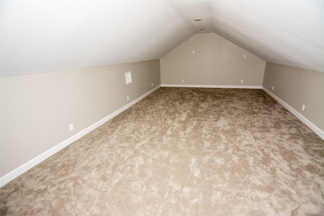 bonus room with carpet and vaulted ceiling