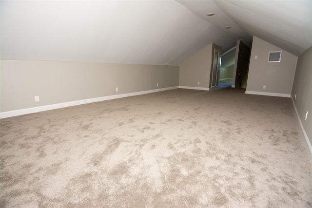 bonus room with carpet flooring and lofted ceiling