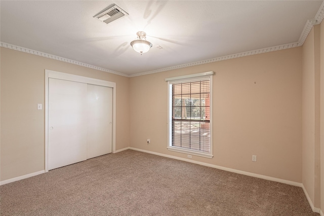 unfurnished bedroom with carpet flooring and a closet