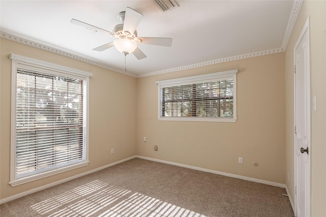 carpeted spare room with ceiling fan