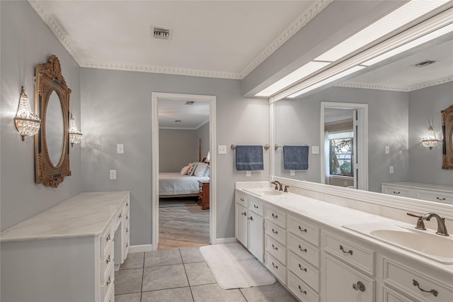 bathroom featuring tile patterned flooring, vanity, and ornamental molding