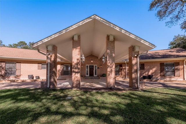 rear view of property featuring a lawn and a patio