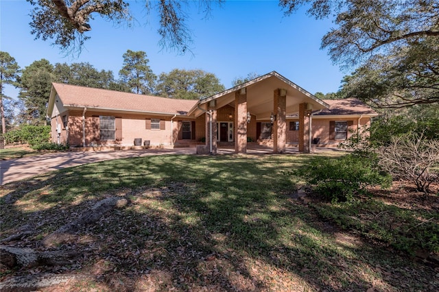 rear view of property with a lawn