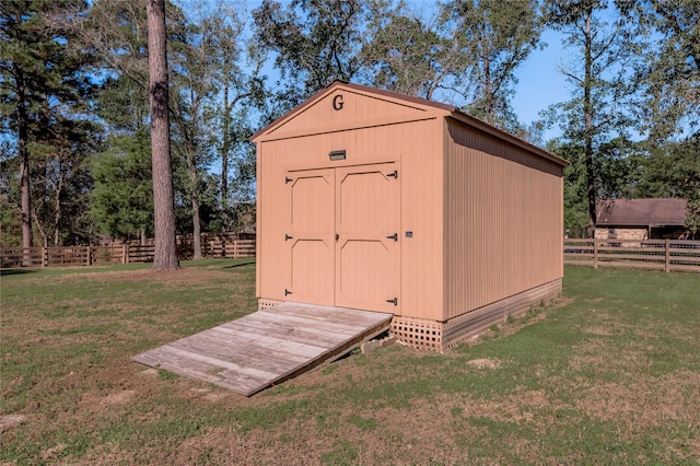 view of outbuilding featuring a yard