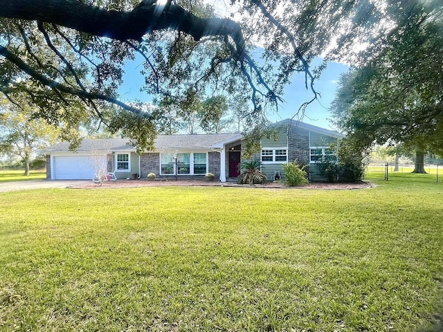 ranch-style home featuring a garage and a front lawn