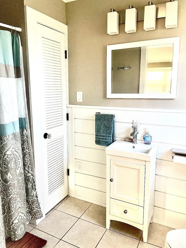 bathroom with tile patterned floors, vanity, and toilet