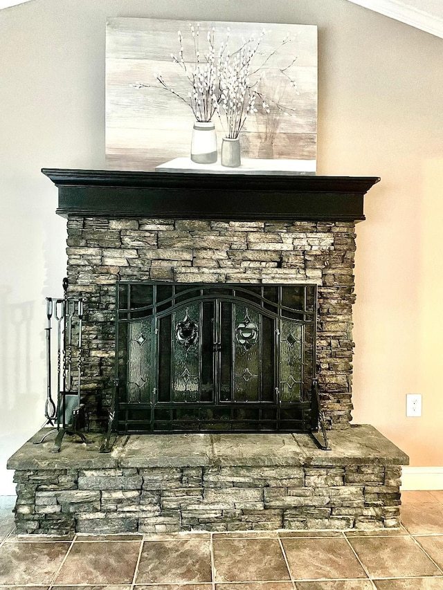 room details featuring a stone fireplace and ornamental molding