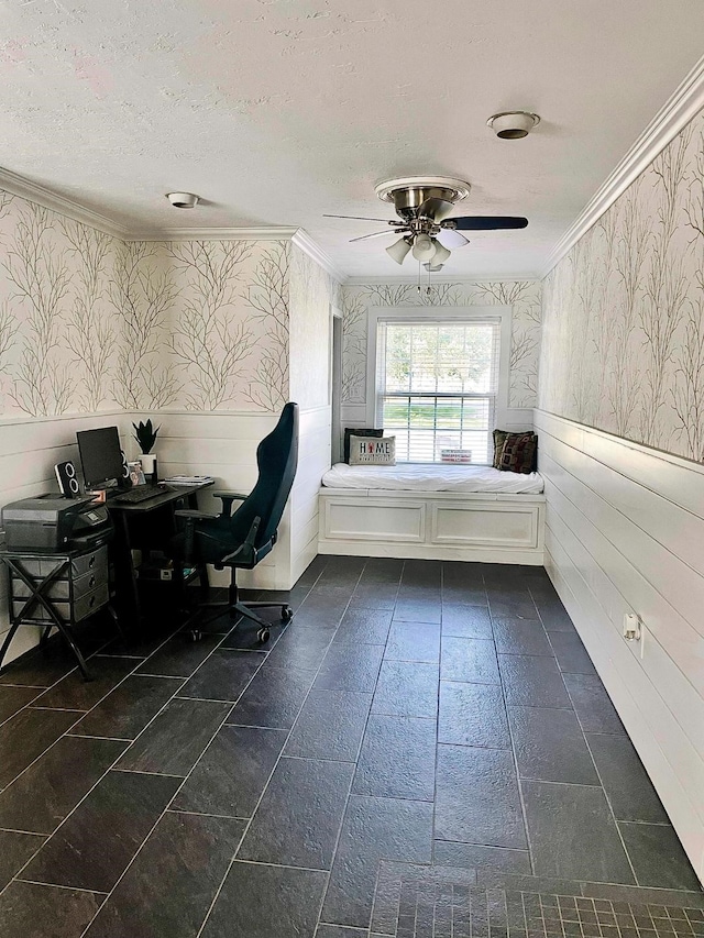 interior space with ceiling fan, ornamental molding, and a textured ceiling