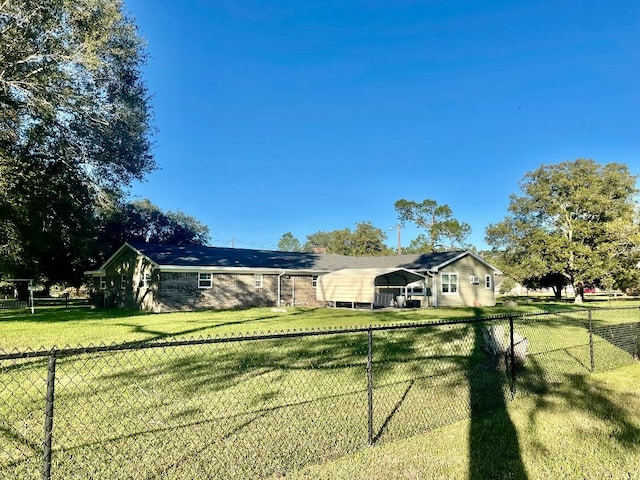 view of front of house with a front lawn and a carport