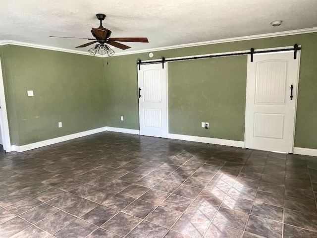 empty room with a barn door, crown molding, ceiling fan, and a textured ceiling