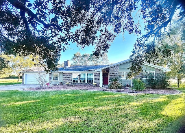 ranch-style house featuring a garage and a front yard