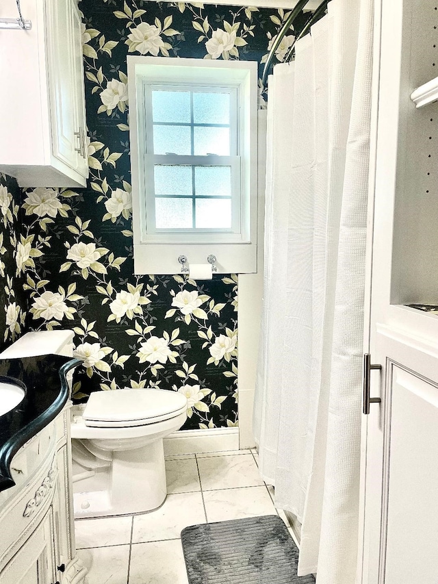 bathroom featuring tile patterned flooring, vanity, and toilet