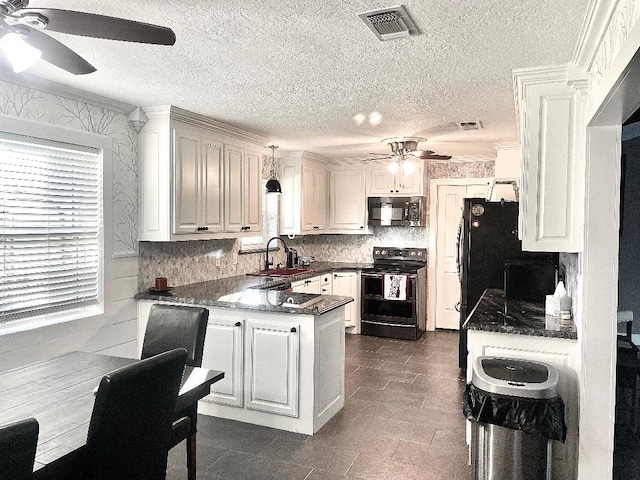 kitchen with pendant lighting, white cabinets, black appliances, and sink