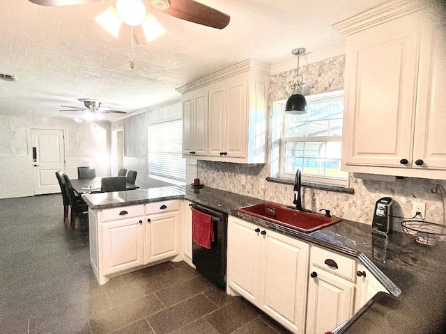 kitchen featuring a textured ceiling, sink, decorative light fixtures, dishwasher, and white cabinetry