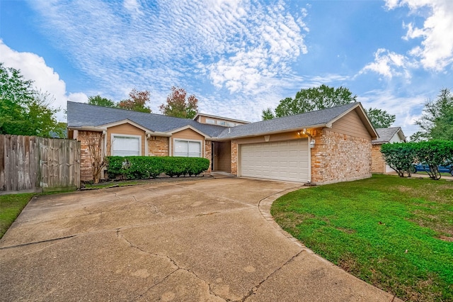 single story home featuring a garage and a front yard