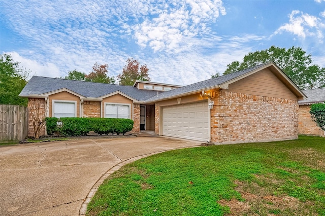 single story home featuring a front yard and a garage